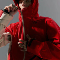 Person wearing a red hooded jacket with text 'Explore Boundlessly' on a gray background