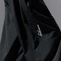 Black snow pants with a brand logo on a gray background