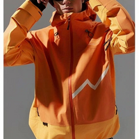Person wearing an orange waterproof snowboarding jacket