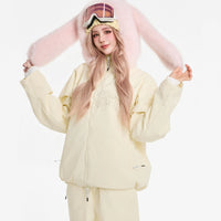 Person wearing a light-colored outfit with pink bunny ears on a white background