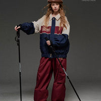 Person in ski gear with poles on a gray background