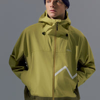 Person wearing a green jacket with a brand logo on a gray background