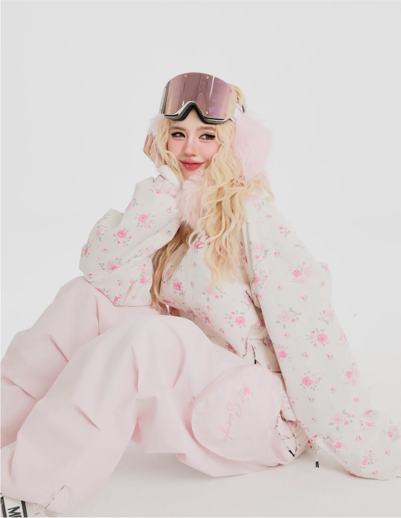 Person wearing a pink skiing jacke with goggles on a white background