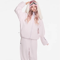 Person wearing a light pink onesie with white fur trim on a white background