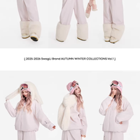 White winter outfit with fur trim worn by a model on a white background