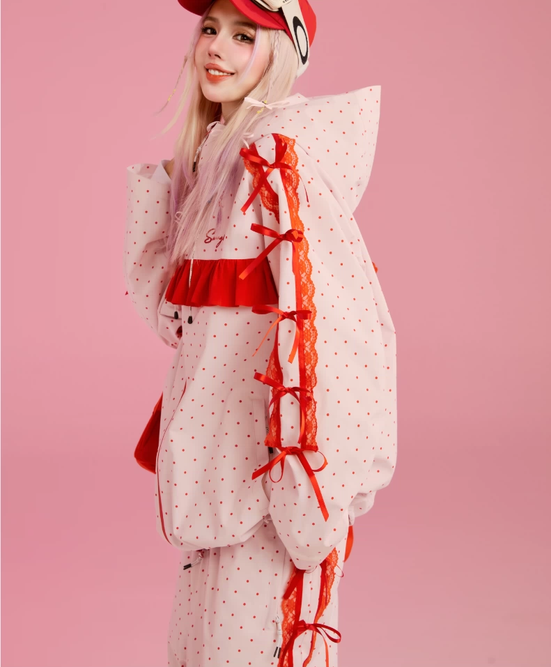 Person wearing a stylish outfit with polka dot jacket and red accents on a pink background, featuring Swag L Brand Autumn Winter Collections.