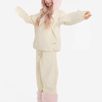 Person wearing a cream-colored bunny costume with pink ears on a white background