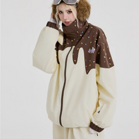 Person wearing a cream-colored onesie with brown accents and goggles on a white background