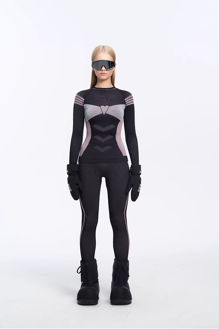 Person wearing a black and gray superhero costume with gloves and boots on a white background