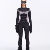 Person wearing a black and gray superhero costume with gloves and boots on a white background