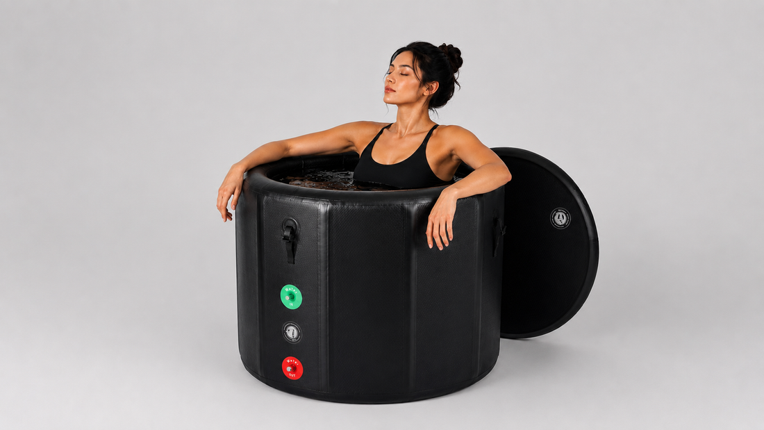 Woman sitting in a black inflatable ice tub on a gray background