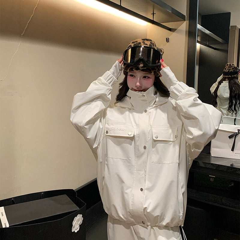 Person wearing a white skiing jacket and leopard print helmet in a store setting
