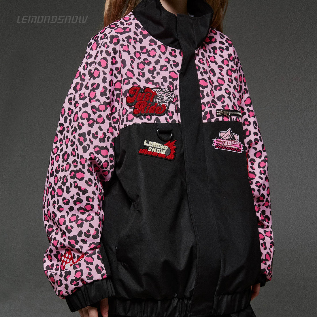 Pink leopard print jacket with black accents and visible branding on a gray background
