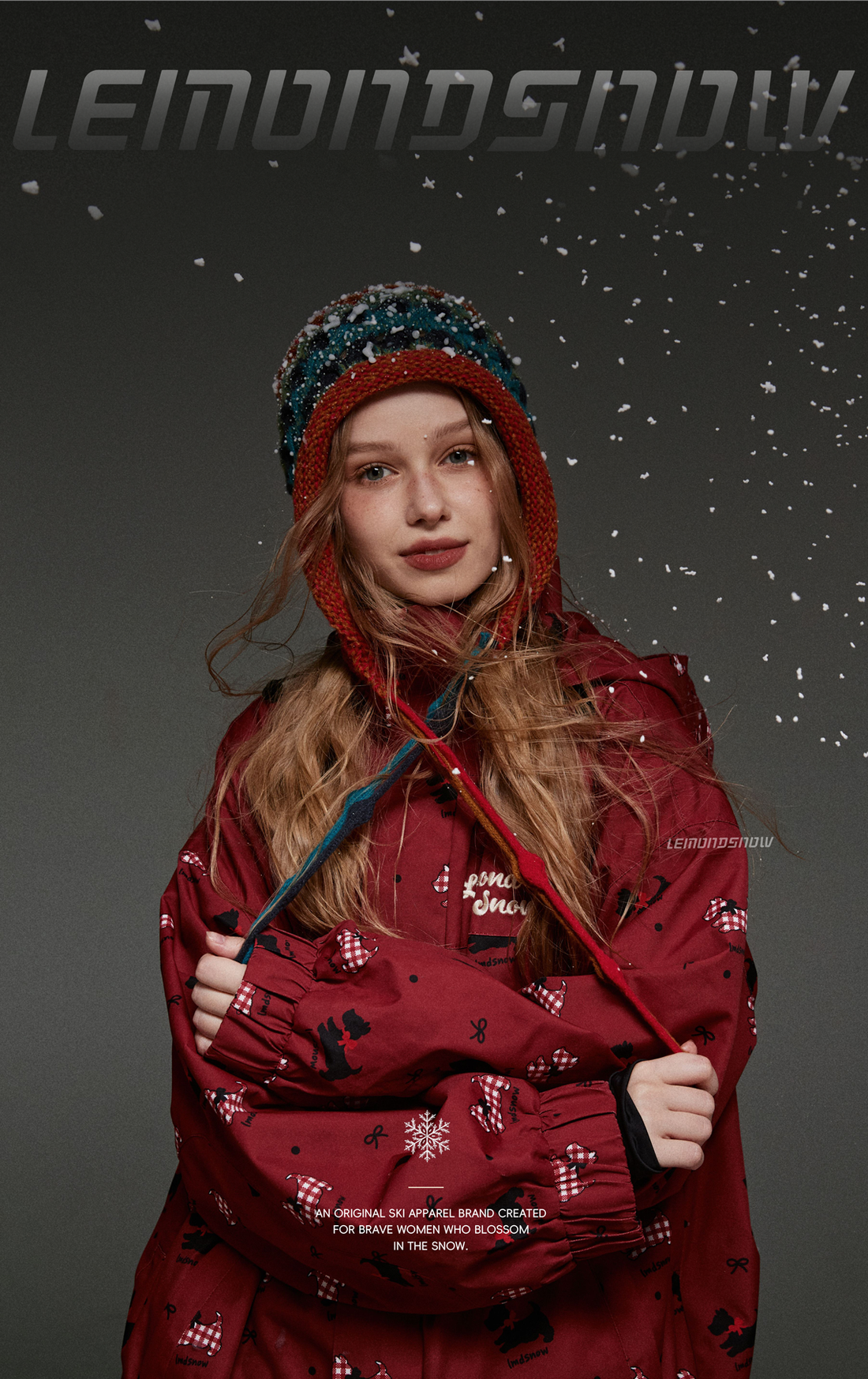 Person wearing a red hooded jacket with snowflake patterns against a dark background.