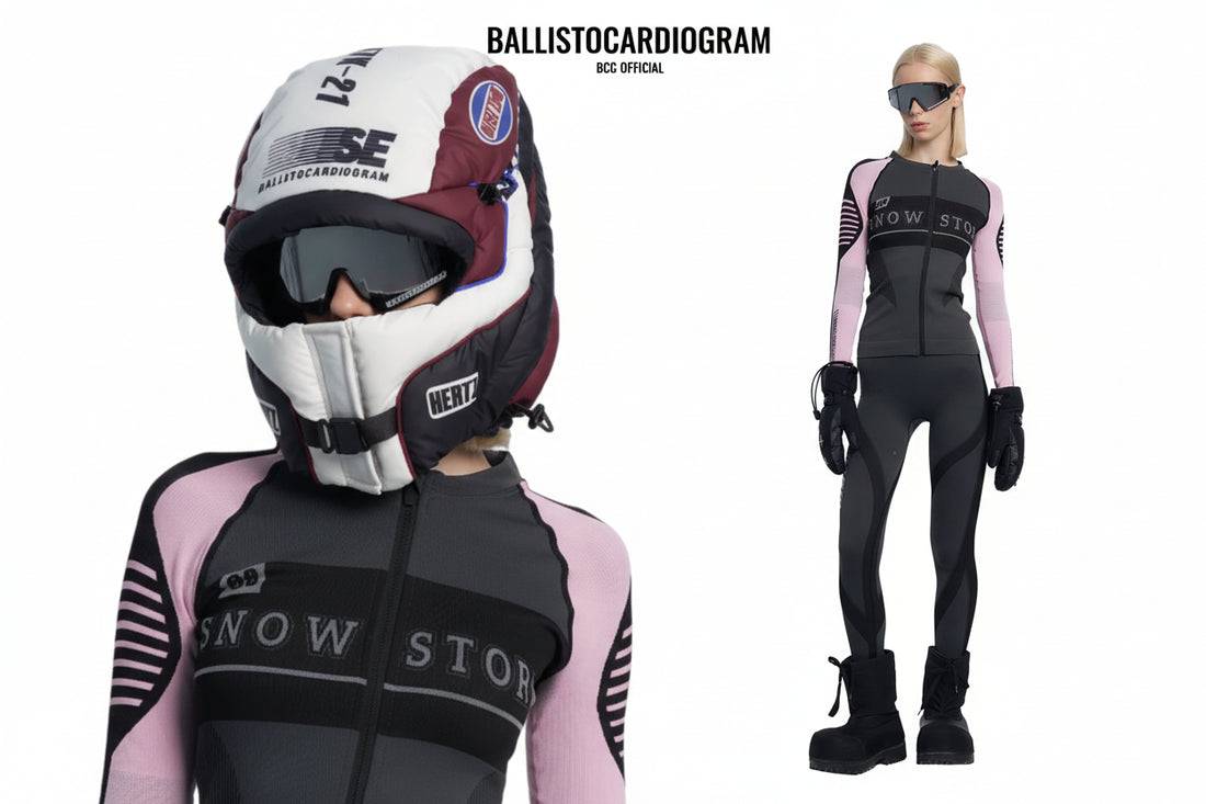 Person wearing a black and pink snow sports outfit with helmet and goggles on a white background.