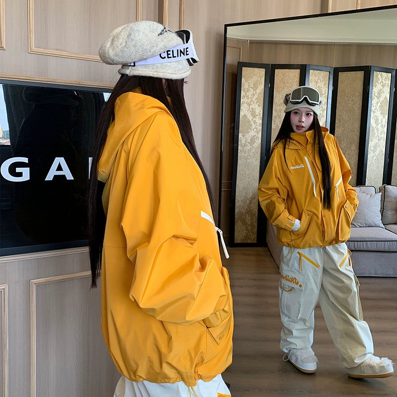 Person wearing a yellow jacket and white pants standing in front of a mirror.