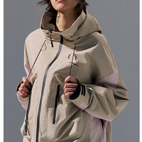 Person wearing a beige jacket on a gray background