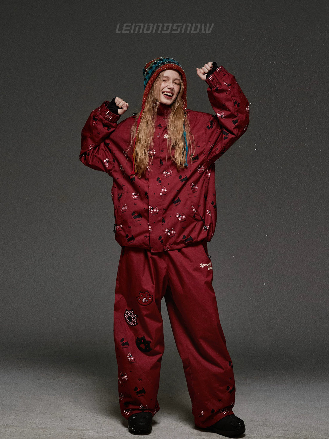 Person wearing a red snowsuit with a gray background