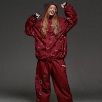 Person wearing a red snowsuit with a gray background