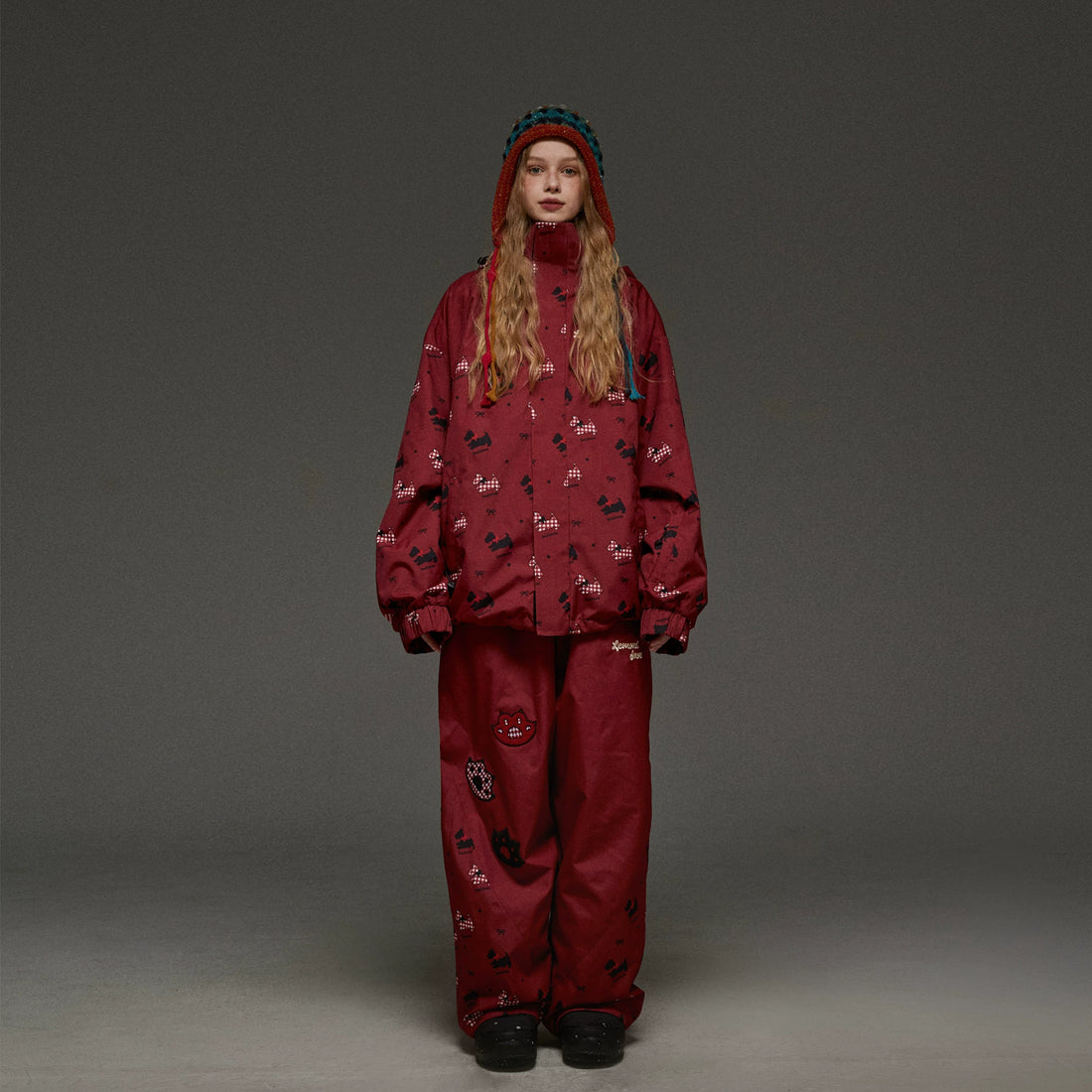Person wearing a red patterned outfit on a gray background