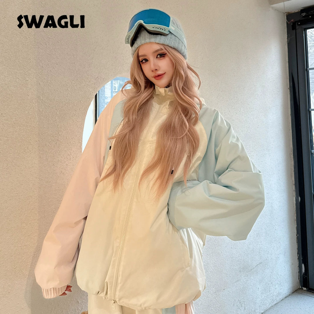 Person wearing a light-colored jacket and hat with &