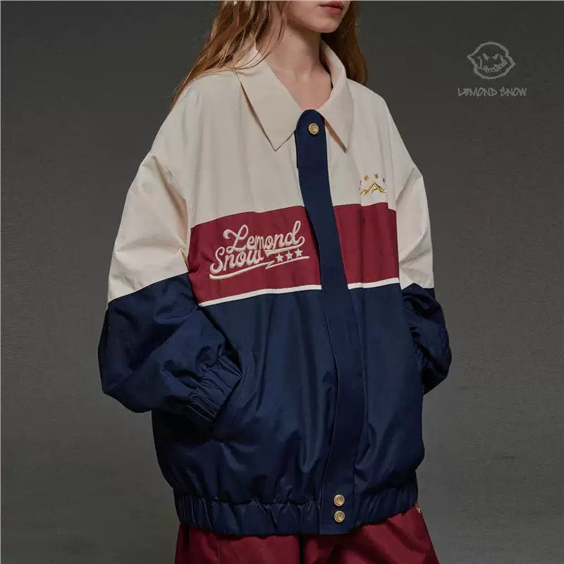 Person wearing a color-blocked jacket with &
