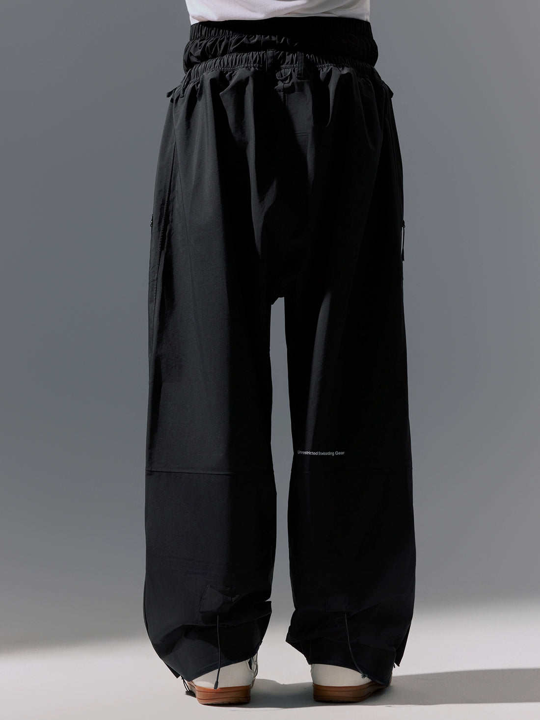 Black wide-leg pants worn by a person on a gray background