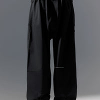Black wide-leg pants worn by a person on a gray background