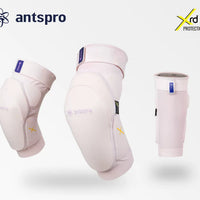 Three Antspro knee/leg protection sleeves in a very light pink color are displayed against a light gray background, with the Antspro logo, Xrd Protection badge, and Japanese text at the bottom.
