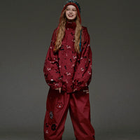 Person wearing a red snowsuit with patterns on a gray background