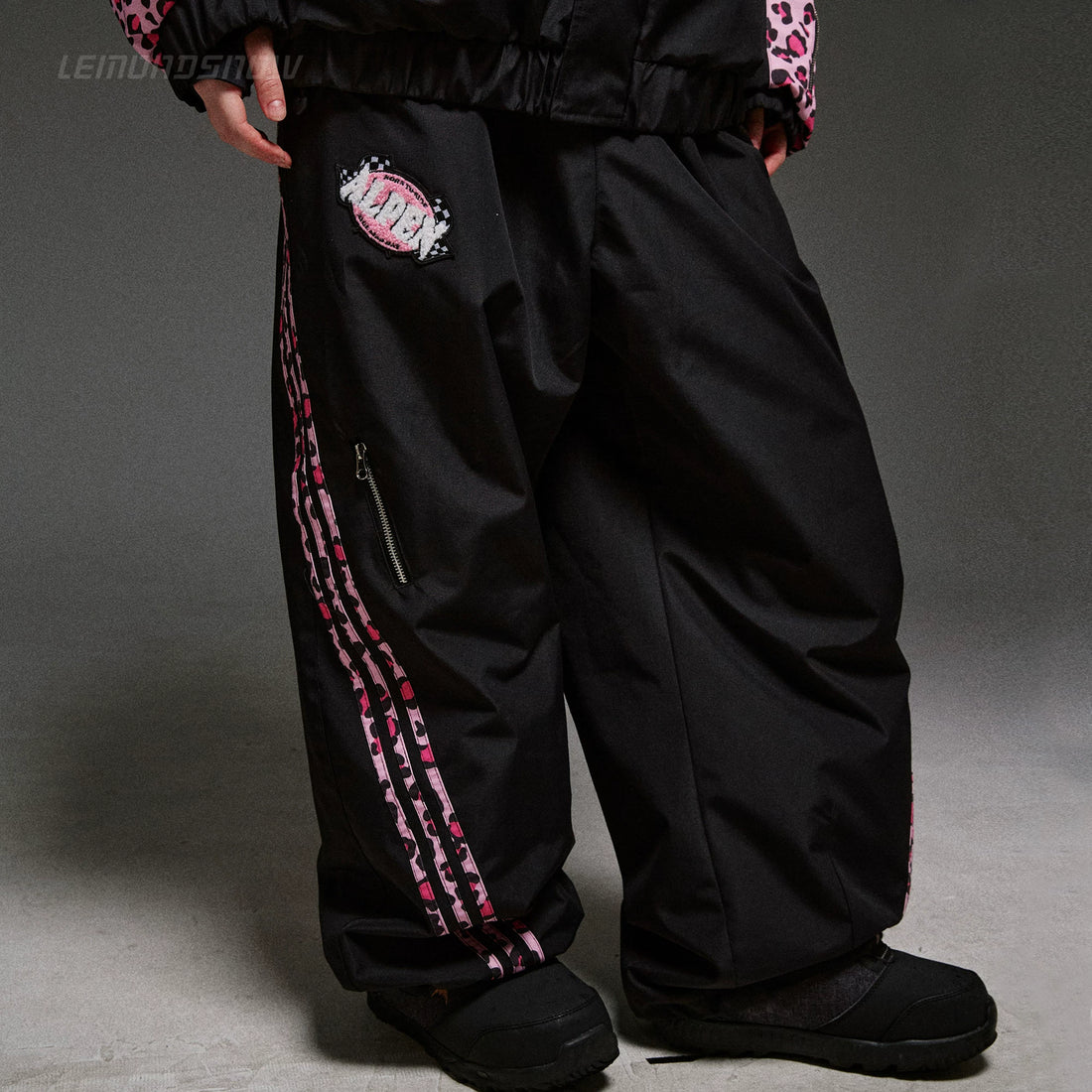 Black pants with pink and white design on a gray background
