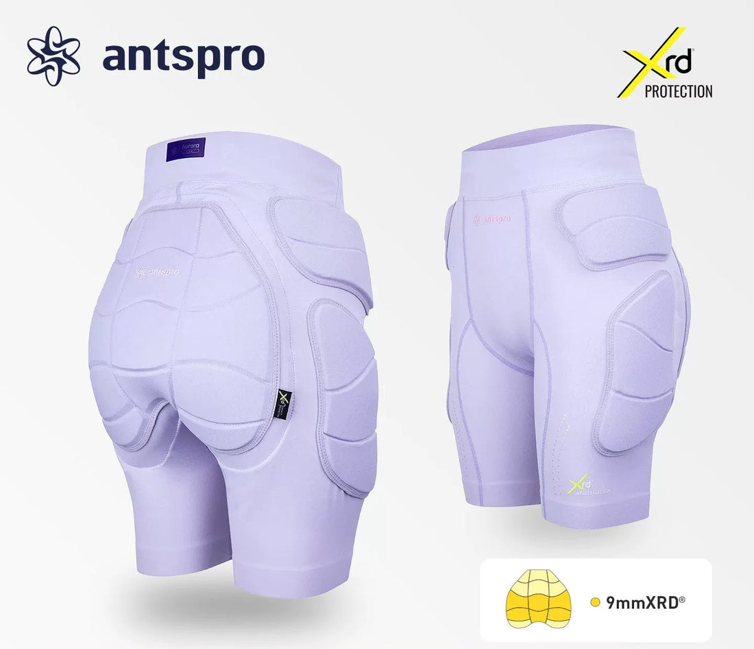 Light purple protective pad shorts shown from the back and side, featuring padded hip, buttock, and knee areas. The image includes the Antspro brand logo, an Xrd Protection badge, and a 9mmXRD feature callout on a clean light gray background.