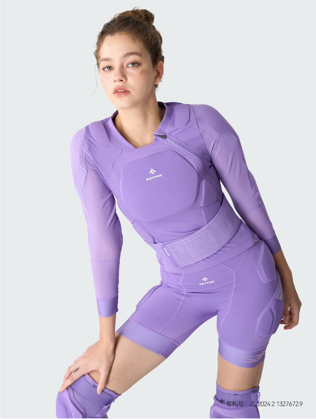 Person wearing a purple protective body armor with &