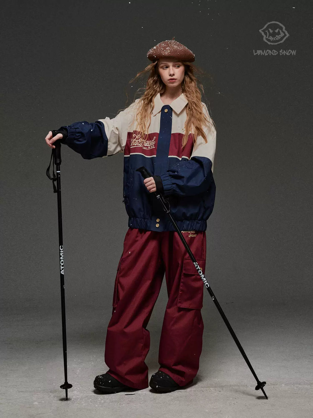 Person in ski gear with poles on a gray background