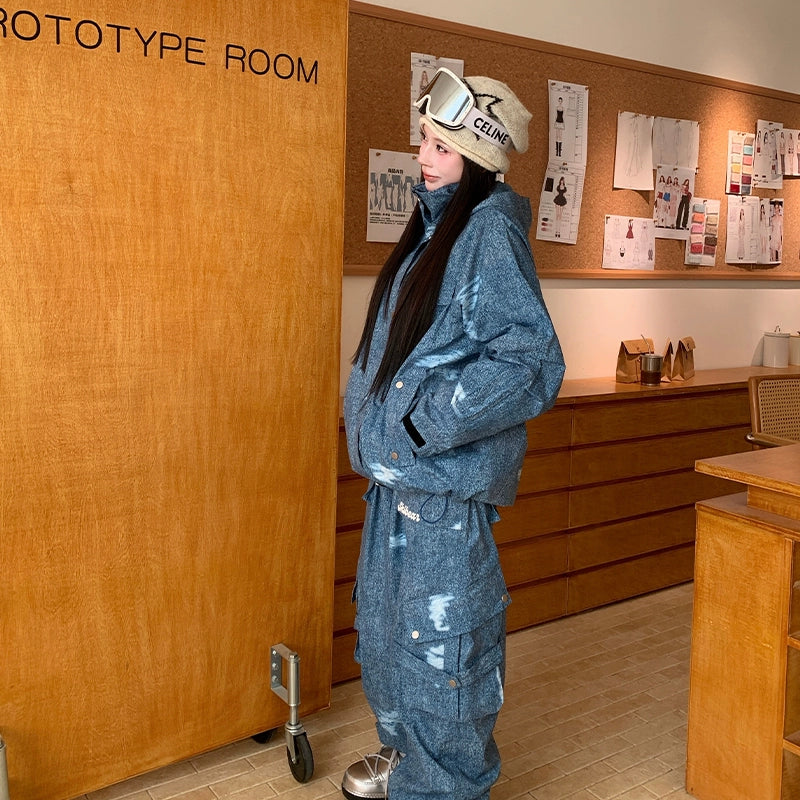 Person wearing a blue denim outfit with a hat in a room labeled &