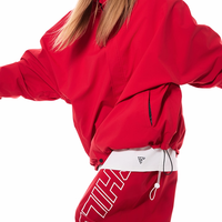 Person wearing a red outfit with visible branding on a white background
