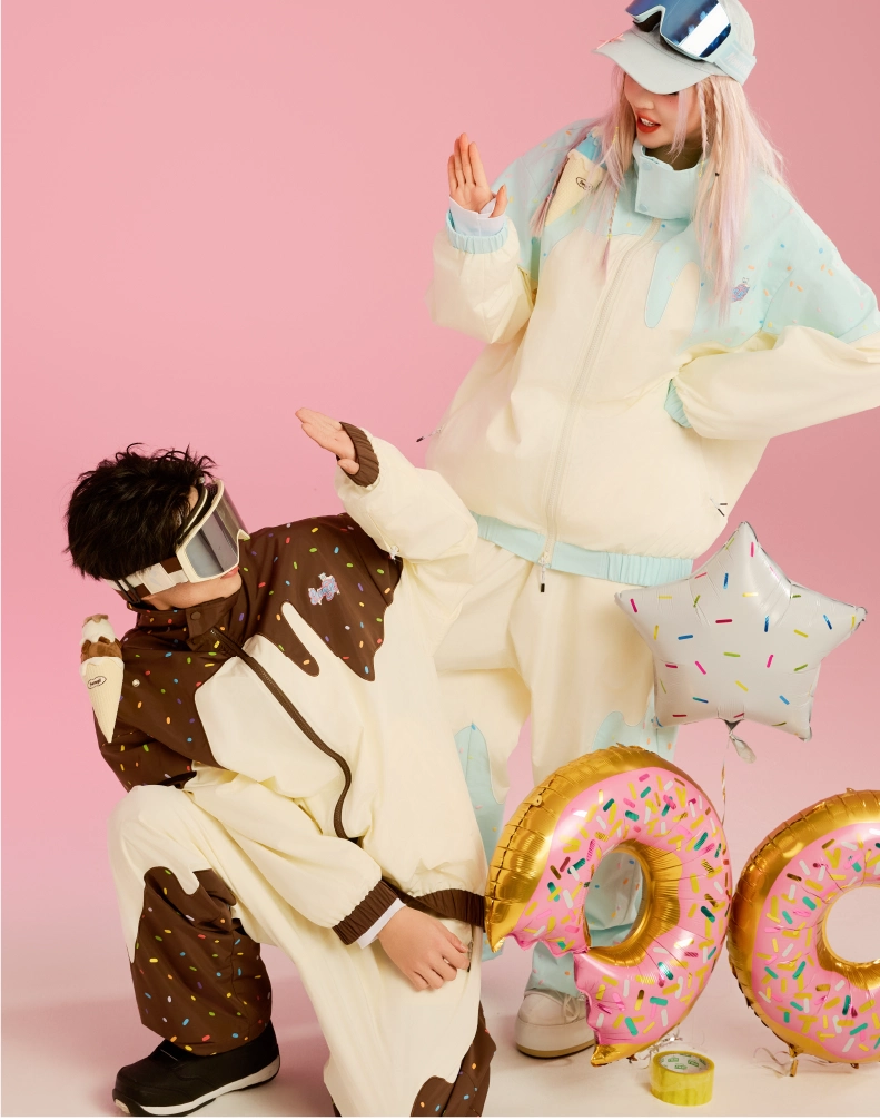 Two people in colorful outfits with large inflatable letters on a pink background